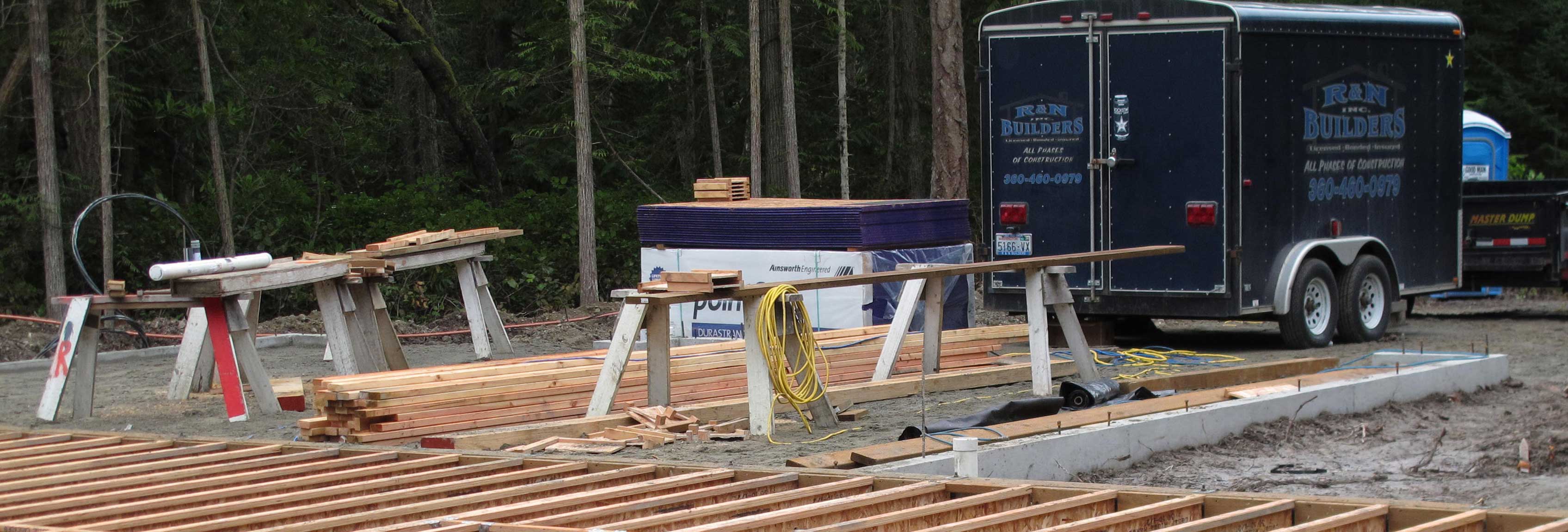 Custom Home Builder-Construction site, home foundation, carpenter and carpenter's truck